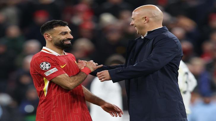 Liverpool's Arne Slot and Mohamed Salah shake hands on the pitch after another victory
